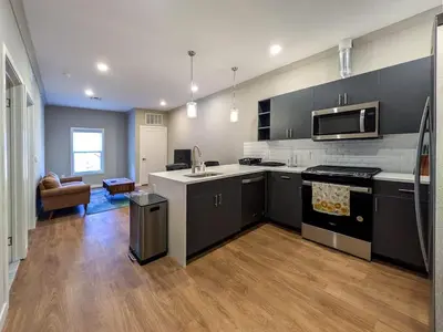 a kitchen with black and white appliances and a living room at 224 Brand New 1 Bedroom 1 Bath 1 Kitchen 1 Liv in Dunellen