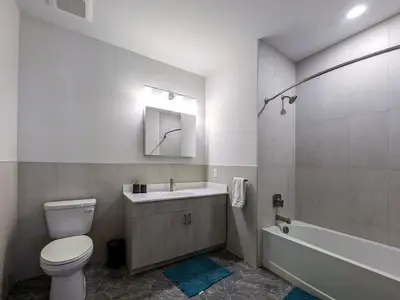 a bathroom with a toilet and a sink and a tub at 224 Brand New 1 Bedroom 1 Bath 1 Kitchen 1 Liv in Dunellen