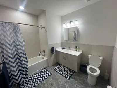 a bathroom with a tub and a toilet and a sink at 315 Brand New 1 Bedroom 1 Bath 1 Full Kit 1 Liv in Dunellen