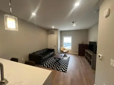 a living room with a couch and a television at 315 Brand New 1 Bedroom 1 Bath 1 Full Kit 1 Liv in Dunellen