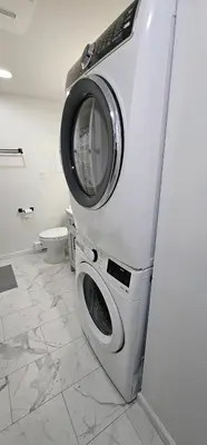 a washing machine in a bathroom with a toilet at Aria Pocono Home in Tobyhanna