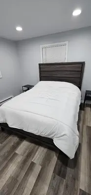 a bedroom with a large bed with white sheets at Aria Pocono Home in Tobyhanna