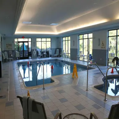 a large swimming pool in a hotel room with a pool at Hampton Inn & Suites Stroudsburg Bartonsville Poconos in Stroudsburg