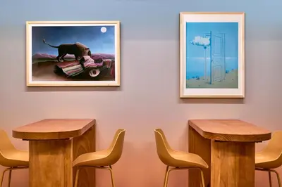 a room with two tables and a picture of a dog on a motorcycle at Now Now NoHo in New York