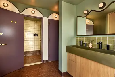 a bathroom with a sink and a mirror at Now Now NoHo in New York