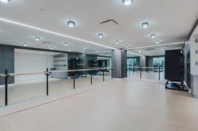 a large room with mirrors and a whiteboard at Blueground Jersey City gym wd ac games NYC-1580 in New York