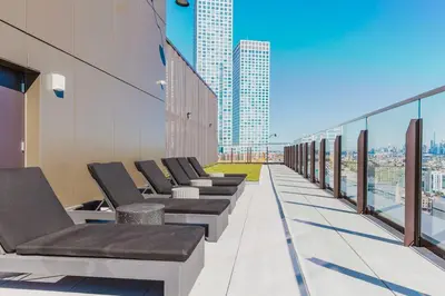 a row of chairs on the roof of a building at Blueground Jersey City gym wd ac games NYC-1580 in New York