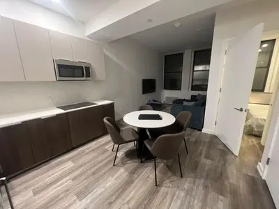 a kitchen and a table and chairs in a room at Luxury 2 BD unit in Financial District in New York