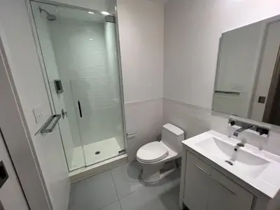 a bathroom with a shower and a toilet and a sink at Luxury 2 BD unit in Financial District in New York