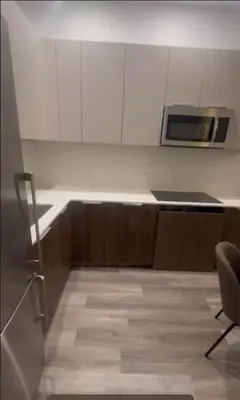 a kitchen with white cabinets and a microwave at Luxury 2 BD unit in Financial District in New York
