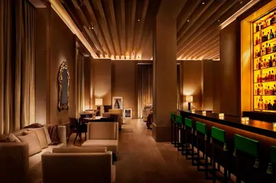 a hotel lobby with a bar and a restaurant at The New York EDITION in New York