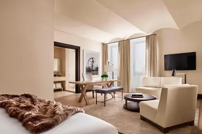 a hotel room with a bed and a living room at The New York EDITION in New York