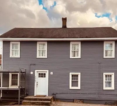a large blue house with a white door at Quaint Renovated Single Family in Matawan