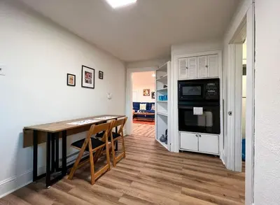 a kitchen with a table and a stove and a refrigerator at Quaint Renovated Single Family in Matawan