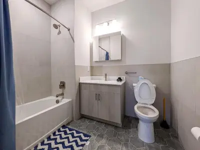 a bathroom with a toilet and a sink and a tub at 213 Brand New 3 Bedroom 2 Bath 1 Full Kit 1 Liv in Dunellen
