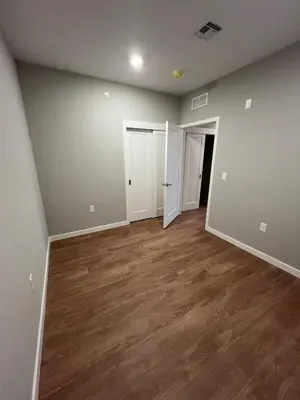 an empty living room with wood floors and white walls at 322 Brand New 2 Bdr 1 KIT 2 BTH 1 LIV in Dunellen