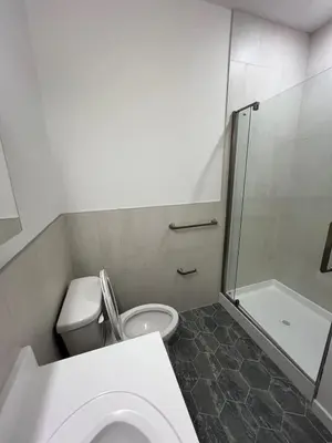 a small bathroom with a toilet and a shower at 322 Brand New 2 Bdr 1 KIT 2 BTH 1 LIV in Dunellen