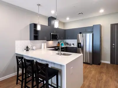 a kitchen with a white counter and black cabinets at 229 Brand New 1 Bedroom 1 Bath 1 Kitchen 1 Liv in Dunellen