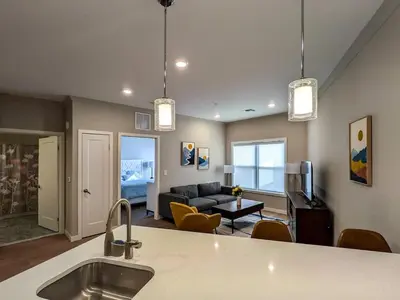 a kitchen and living room with a couch and a table at 210 Brand New 1 Bedroom 1 Bath 1 Full Kit 1 Liv in Dunellen
