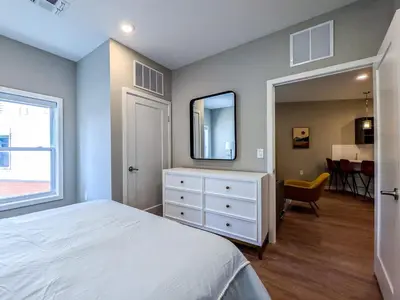 a bedroom with a bed and a dresser with a mirror at 324 Brand New 1 Bedroom 1 Bath 1 Kitchen 1 Liv in Dunellen