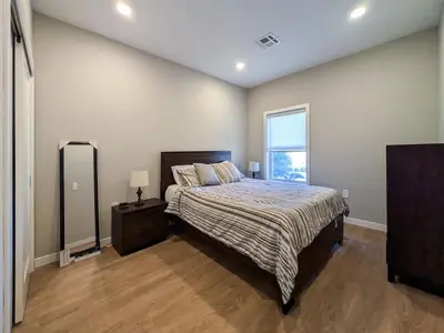 a bedroom with a large bed and a window at 324 Brand New 1 Bedroom 1 Bath 1 Kitchen 1 Liv in Dunellen
