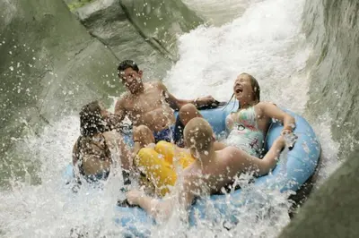a group of people on a raft in a waterfall at Luxe 10 guest Cottage Ski-Golf-Firepit-Lakes-Hike in Vernon Township