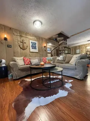 a living room with a table and a couch at Racc00ns Retreat in Lake Harmony