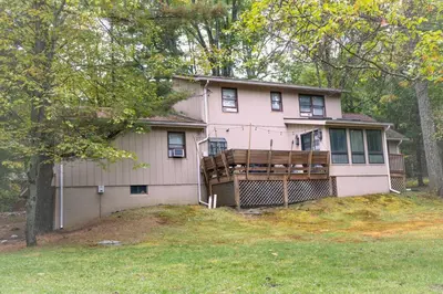 a pink house with a fence in front of it at Racc00ns Retreat in Lake Harmony