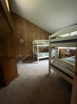 a bedroom with two bunk beds in a room at Racc00ns Retreat in Lake Harmony