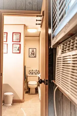 a small bathroom with a toilet in a hallway at Racc00ns Retreat in Lake Harmony