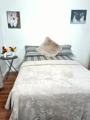 a bedroom with a bed with a pillow on it at Fada Guest House - 38 Yates Ave Newark in Newark
