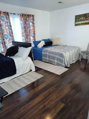 a living room with two beds and a couch at Fada Guest House - 38 Yates Ave Newark in Newark