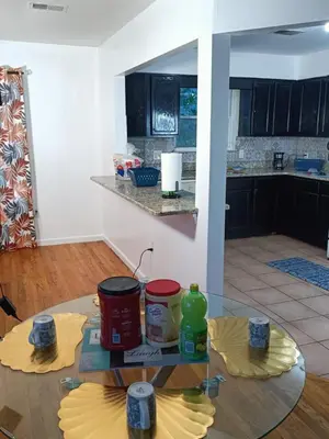 a kitchen with a glass table in a room at Fada Guest House - 38 Yates Ave Newark in Newark