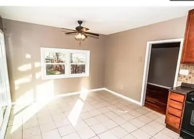 a living room with a ceiling fan and a tile floor at 107 Quaint Renovated Single Family 3 Bdrm House in Old Bridge