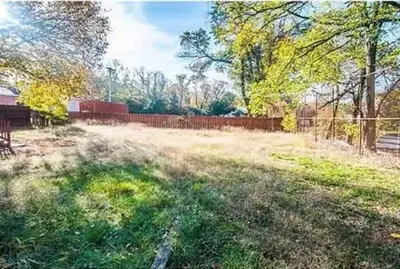 a yard with a fence and a field of grass at 107 Quaint Renovated Single Family 3 Bdrm House in Old Bridge