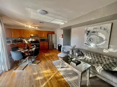 a living room with a couch and a kitchen at 4 bedroom apt in Newark in Newark