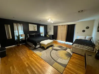 a bedroom with two beds and a living room at 4 bedroom apt in Newark in Newark