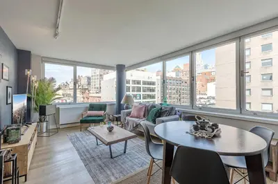 a living room with a couch and a table at E Village 1BR w Doorman Gym nr Union Sq NYC-10 in New York