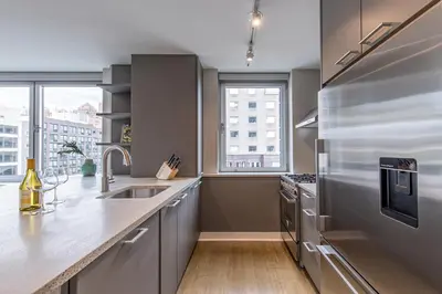 a kitchen with stainless steel appliances and a large window at E Village 1BR w Doorman Gym nr Union Sq NYC-10 in New York