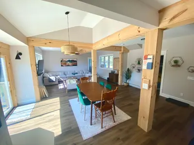 a dining room and living room with a table and chairs at Upper Delaware River House in Equinunk