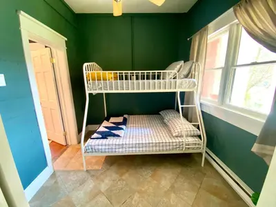 a room with a bunk bed in a green wall at Upper Delaware River House in Equinunk