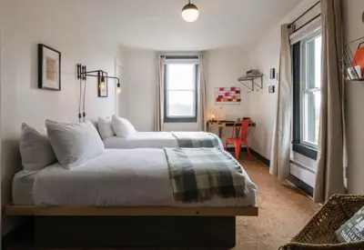 a bedroom with a bed and a table in a room at The Arnold House in Livingston Manor