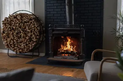 a fireplace with a pile of fire wood at The Arnold House in Livingston Manor