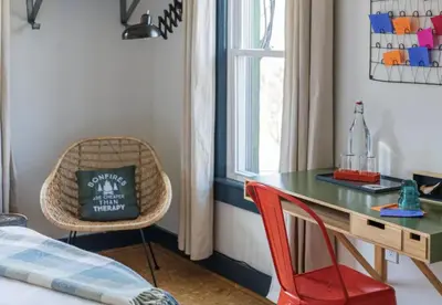 a room with a table and a chair and a window at The Arnold House in Livingston Manor