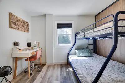 a small bedroom with a bunk bed and a desk at 2 Bedroom Condo in Tannersville - 6 Minutes from Camelback Mountain in Tannersville