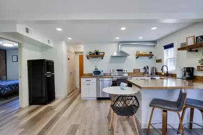 a kitchen with a black refrigerator and a table at 2 Bedroom Condo in Tannersville - 6 Minutes from Camelback Mountain in Tannersville