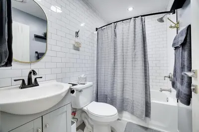 a white bathroom with a sink and a toilet at 2 Bedroom Condo in Tannersville - 6 Minutes from Camelback Mountain in Tannersville