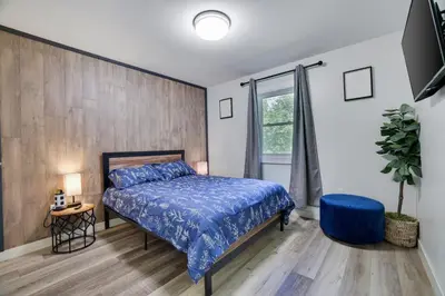 a bedroom with a bed with a blue comforter at 2 Bedroom Condo in Tannersville - 6 Minutes from Camelback Mountain in Tannersville