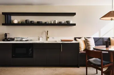 a kitchen with a sink and a counter with a table at Stockton Inn in Stockton