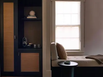 a bedroom with a window and a bed and a table at Stockton Inn in Stockton